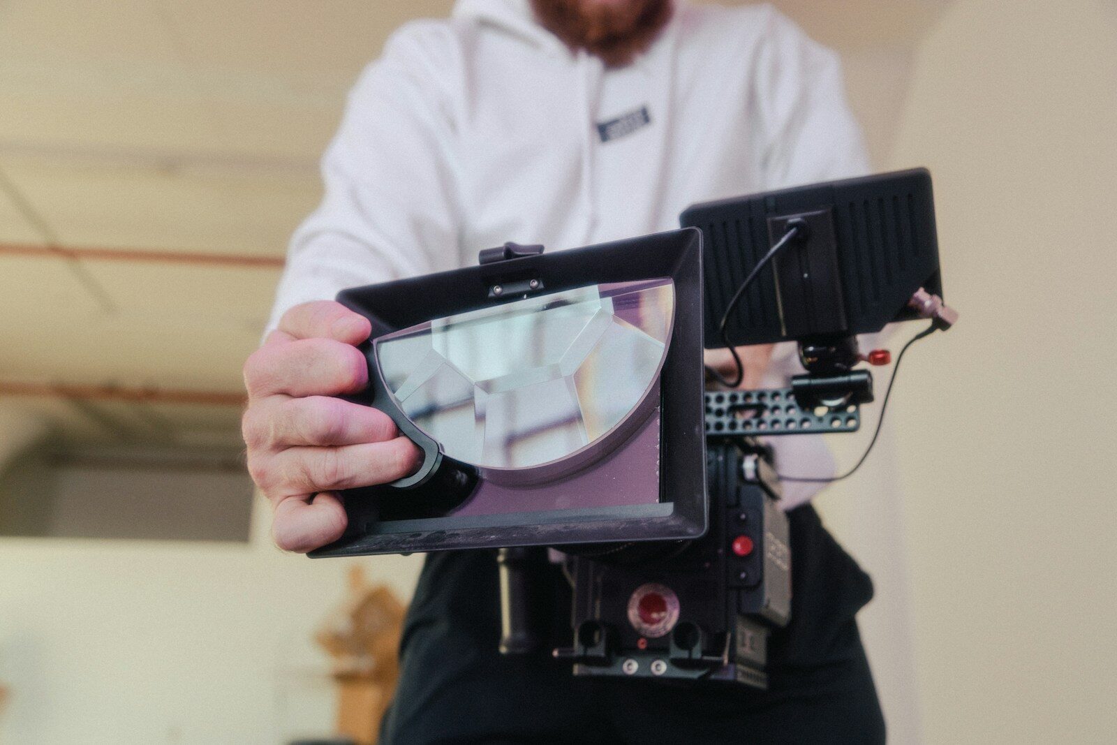 person holding black and silver camera